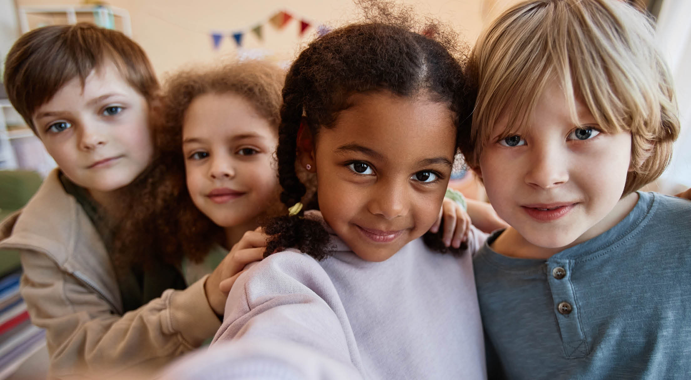 POV diverse group of happy children taking selfie photo together and smiling at camera