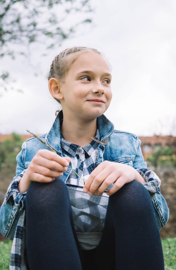 little girl playing in the park in green background